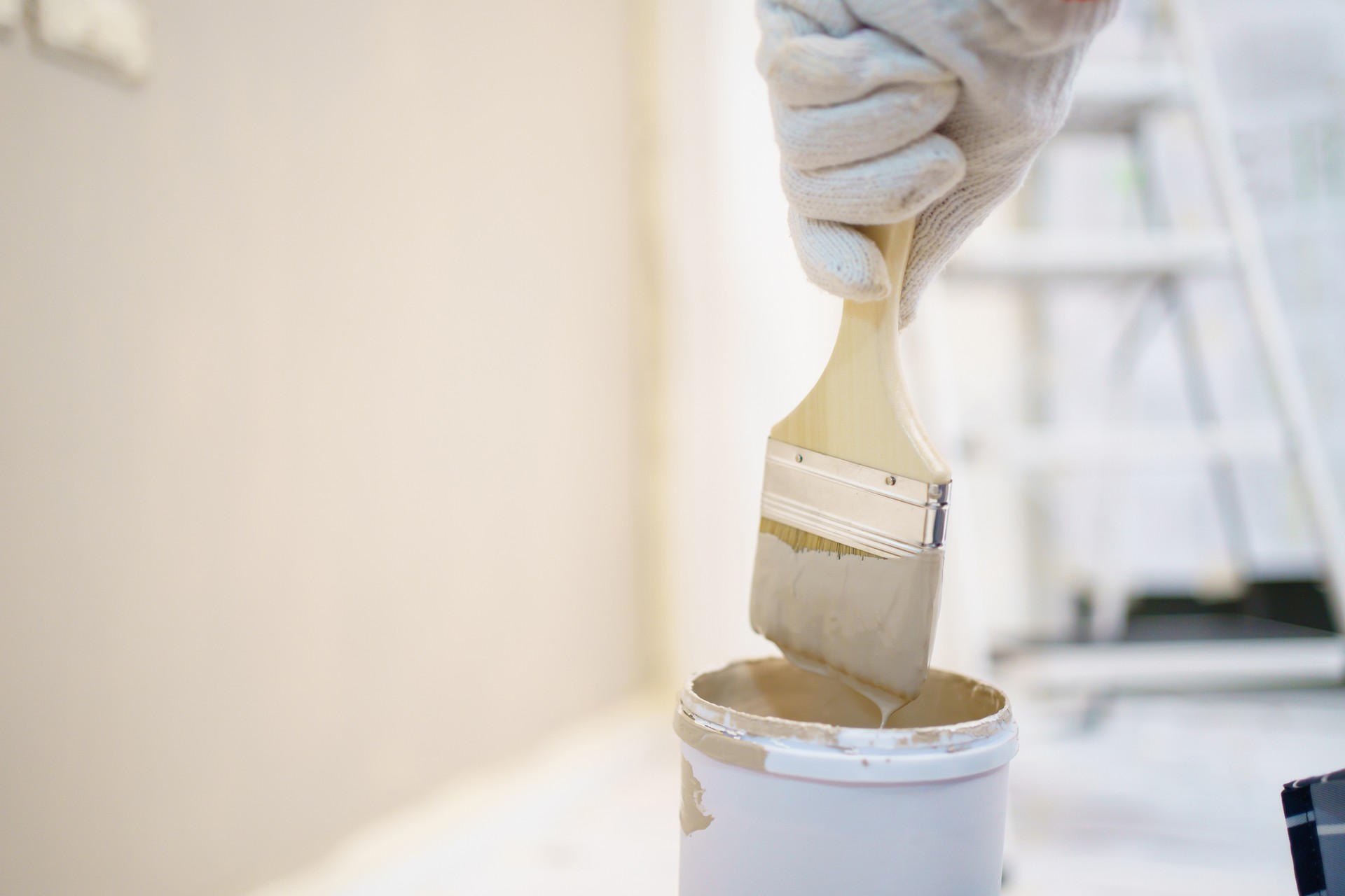 Woman painting the wall at home.